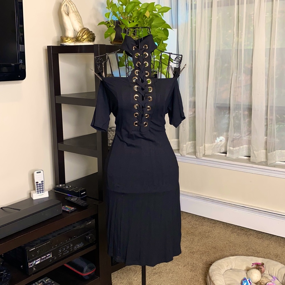 Off the shoulder dress. Adjustable lace tie detail. Gold hardware. Cuff neck.